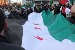 Large Syrian revolutionary flag at the central point of the rally