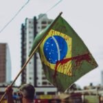 man in green shirt holding yellow and green flag