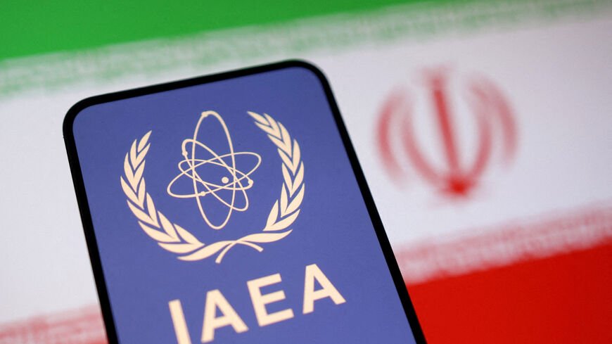 FILE PHOTO: Illustration shows International Atomic Energy Agency (IAEA) logo and Iranian flag
