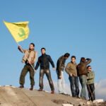 posing with hezbollah flag