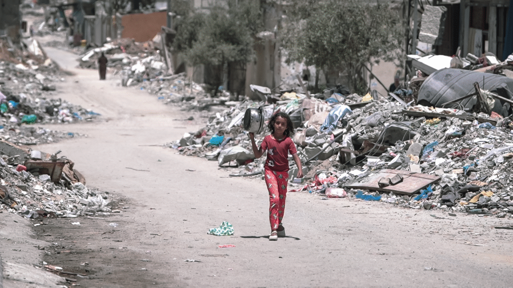 A_girl_walks_inside_Gaza_during_the_Gaza-Israel_war_to_get_food